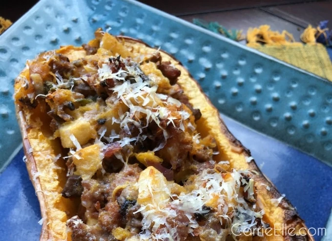 Apple  stuffed squash in a blue baking dish.