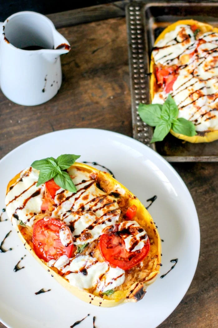 Caprese Stuffed Spaghetti Squash on a plate with balsamic drizzle.