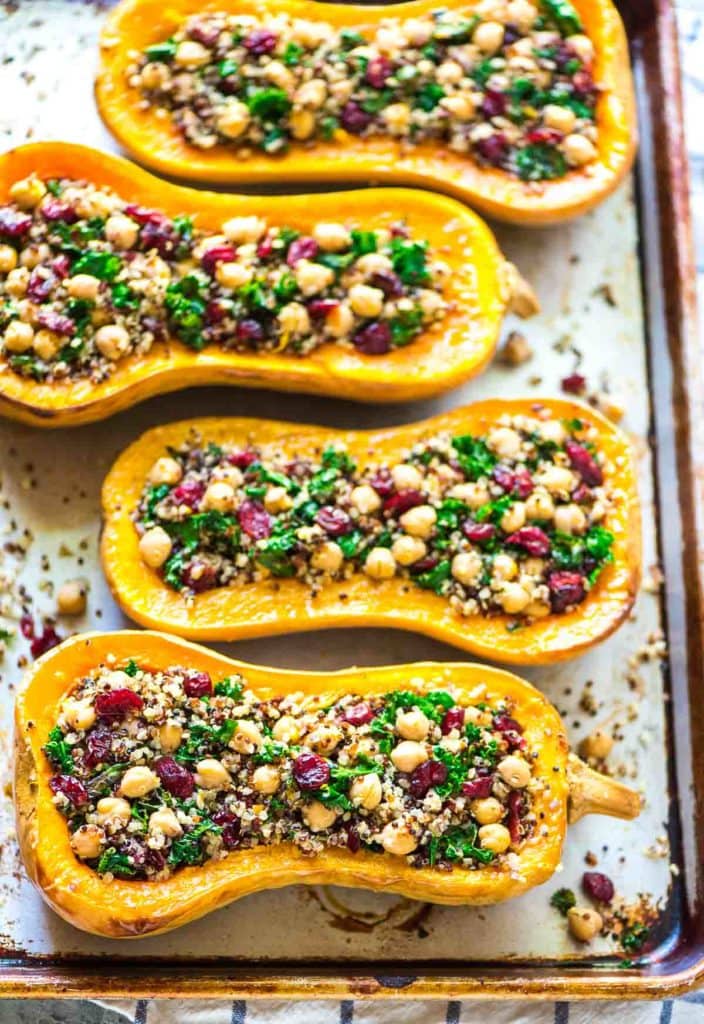 Quinoa Stuffed Butternut Squash With Cranberries And Kale on a baking tray.