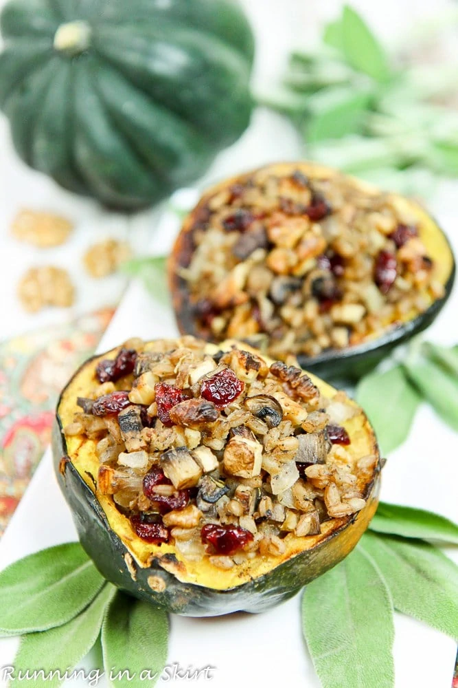 Sausage and apple stuffed squash on the table with a squash beside them.