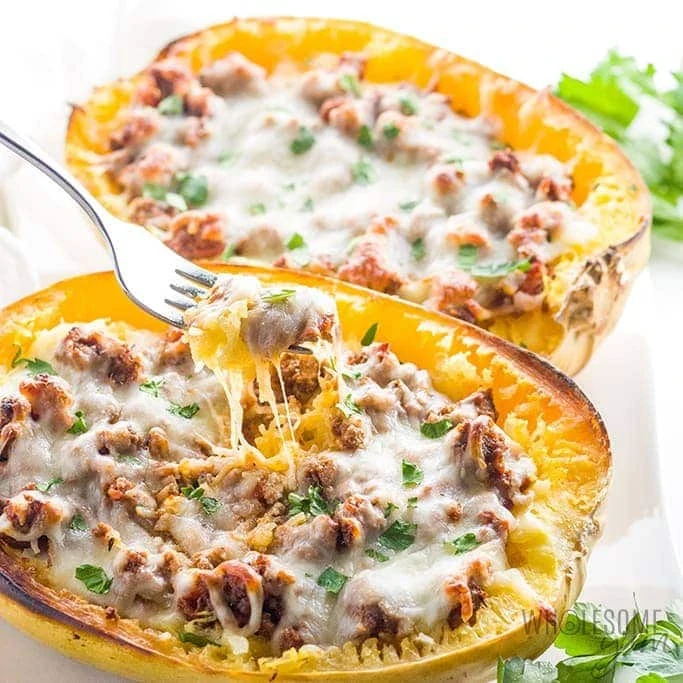 Low carb stuffed squash with a fork grabbing a bit.