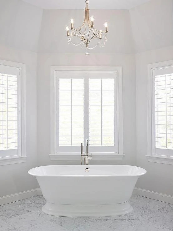 Benjamin Moore Paper White walls in a master bathroom with a free standing tub.