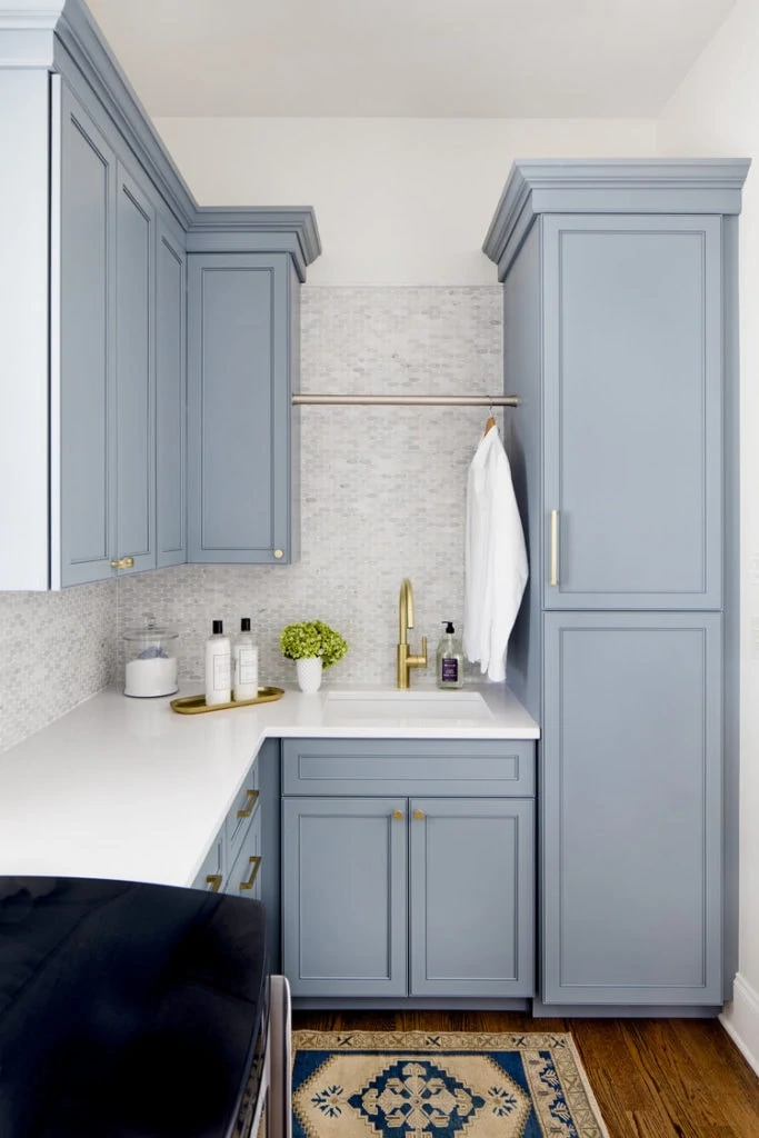 Laundry room cabinets painted in Benjamin Moore Van Courtland Blue. This is a gorgeous blue gray paint color option!