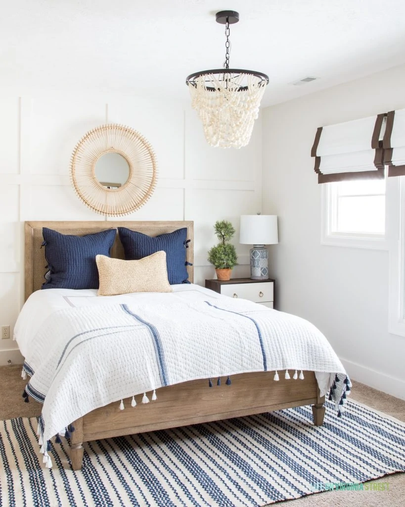 A navy blue and white guest bedroom painted with Benjamin Moore Classic Gray.