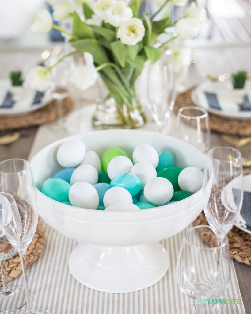 A white ceramic footed bowl filled with faux Easter eggs! Such a fun decorating idea for spring or Easter!
