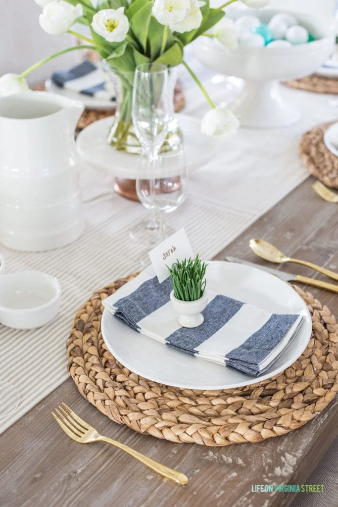 An spring and Easter place setting featuring neutrals mixed with navy blue and green!