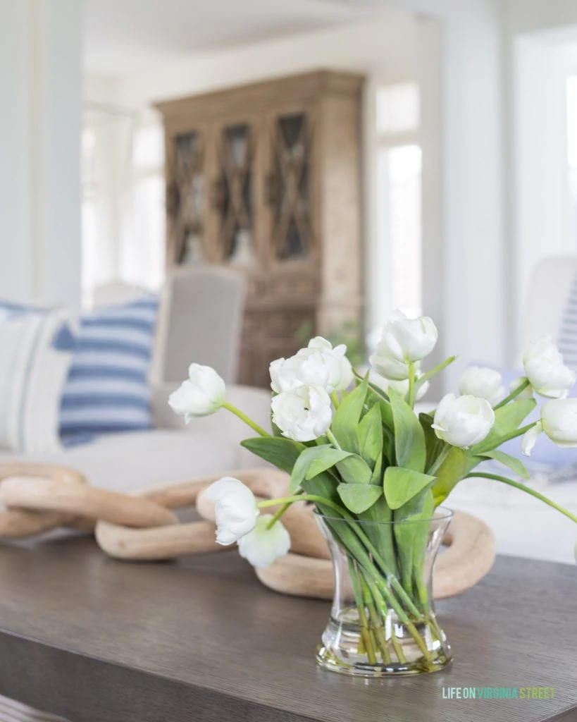 Faux white tulips in a blue and white spring living room.