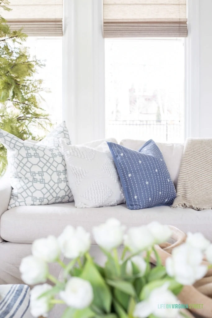 An eclectic pairing of coastal blue and white throw pillows for spring.