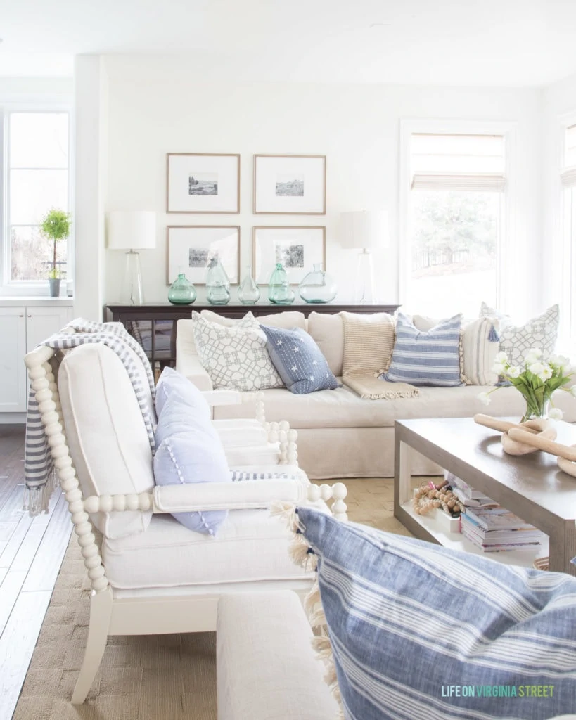 A blue, white, and neutral spring living room. I love all the stripes and pops of green from the botanicals!