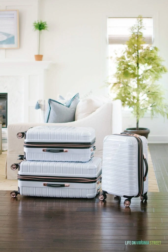 I love this white hard-case luggage with rose gold spinner wheels!