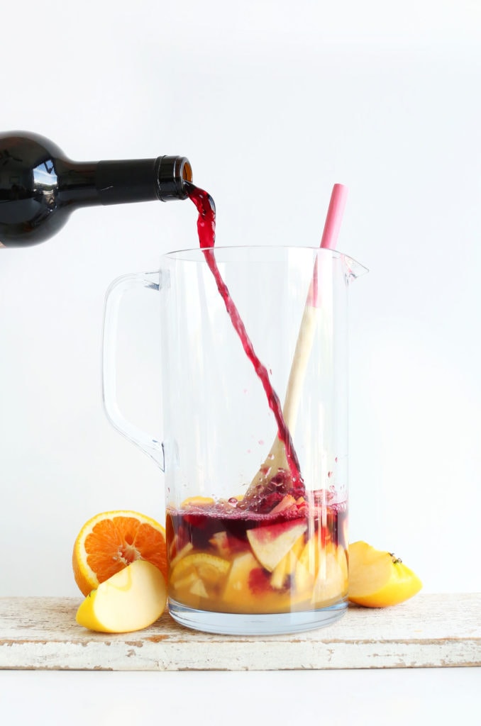 Easy Traditional Red Sangria being poured into a glass jug.