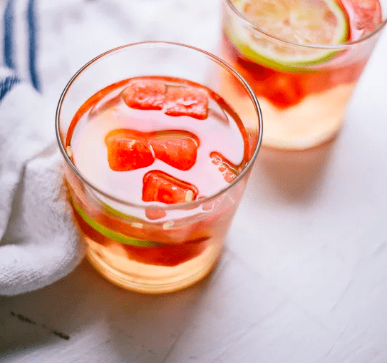 Watermelon White Sangria in a glass cup on the counter.