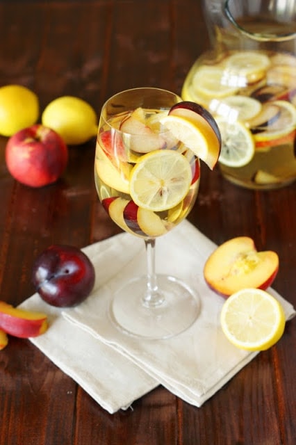 White Sangria with Nectarines, Plums, & Lemons on the table.