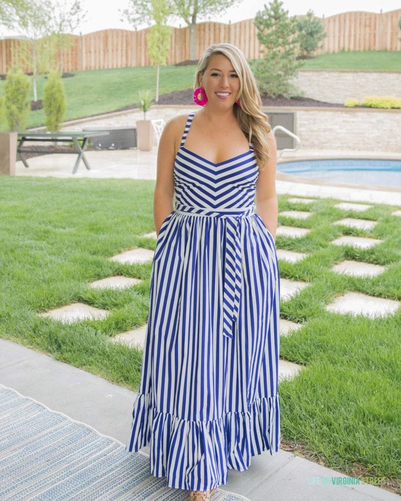 A dark blue and white striped dress with the woman wearing pink large earrings.
