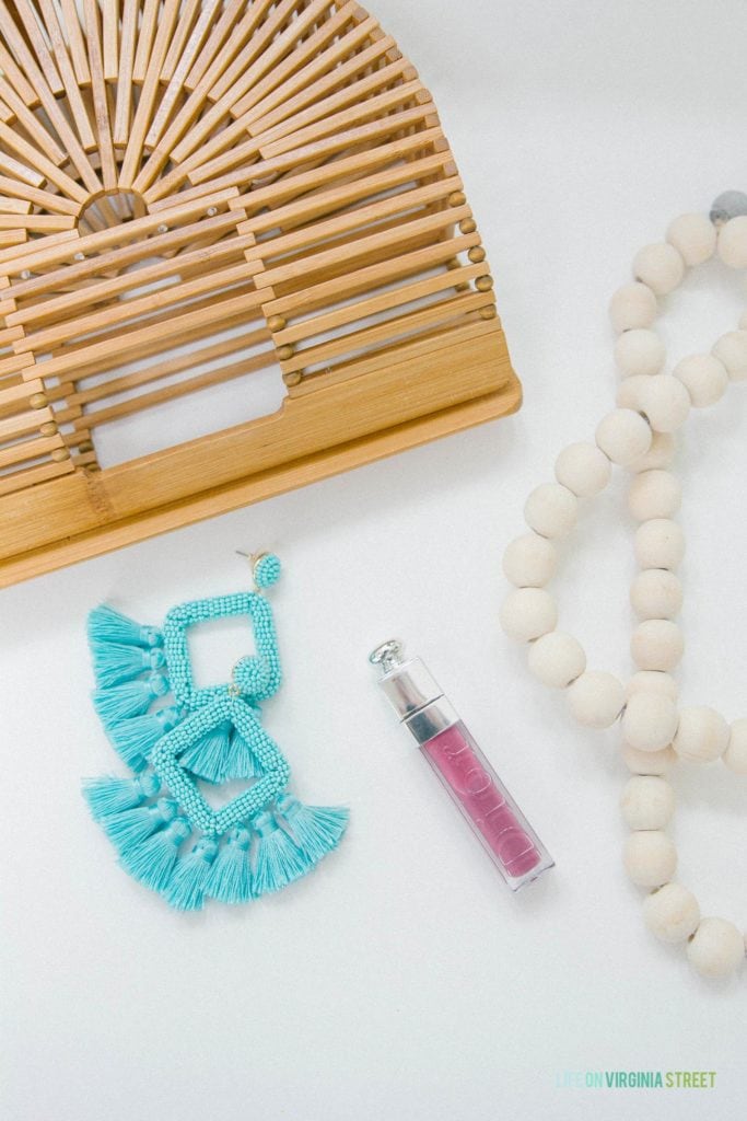 The bamboo pure, blue tassel earrings and lipstick pictured on the counter.