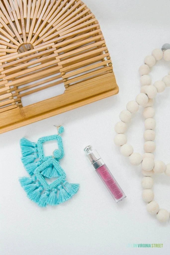 The bamboo pure, blue tassel earrings and lipstick pictured on the counter.