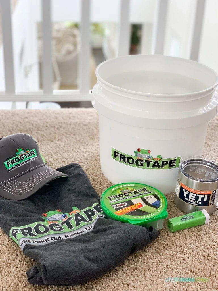Frogtape hat, tape, shirt and bucket on the carpet.