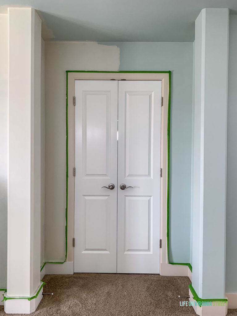 Putting Frogtape around the door ready for painting.