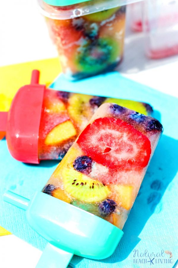 Healthy Homemade Fruit with multi coloured chunks of fruit in the popsicles.
