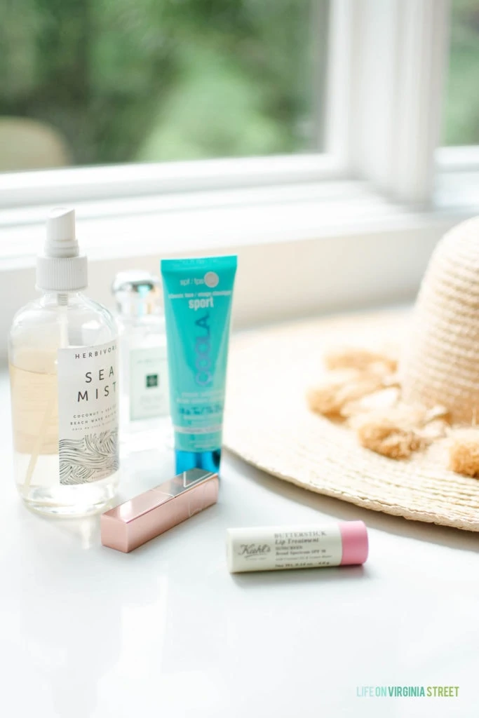 A few of my favorite summertime essentials, including a beachy wave hair mist, face sunscreen, SPF lip treatment, raffia hat and more!