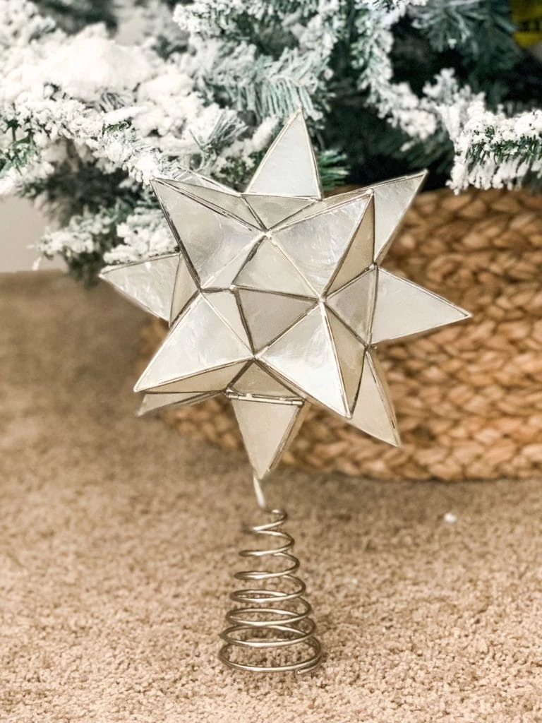 A star topper for the Christmas tree on the rug displayed.