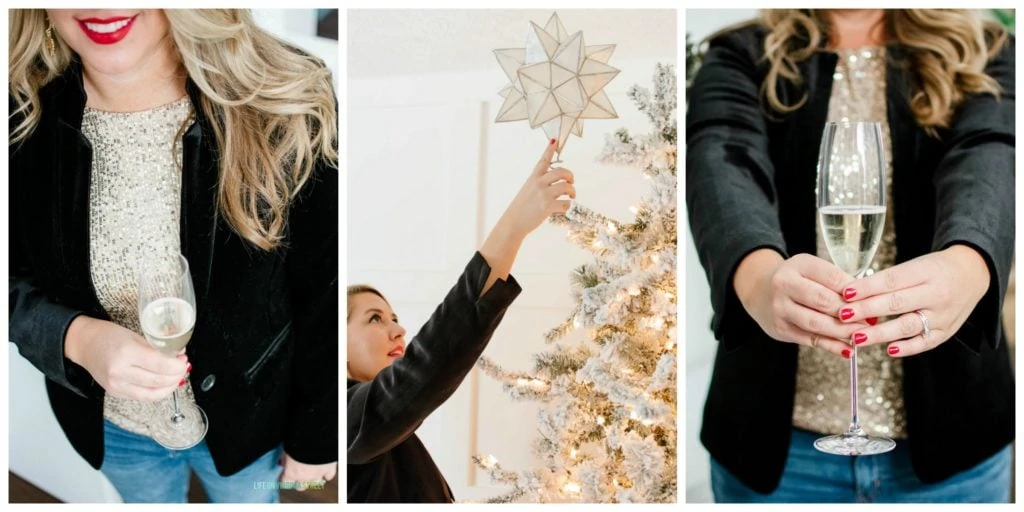 A gold flocked Christmas tree with Sarah holding a champagne glass with red nails and lips.