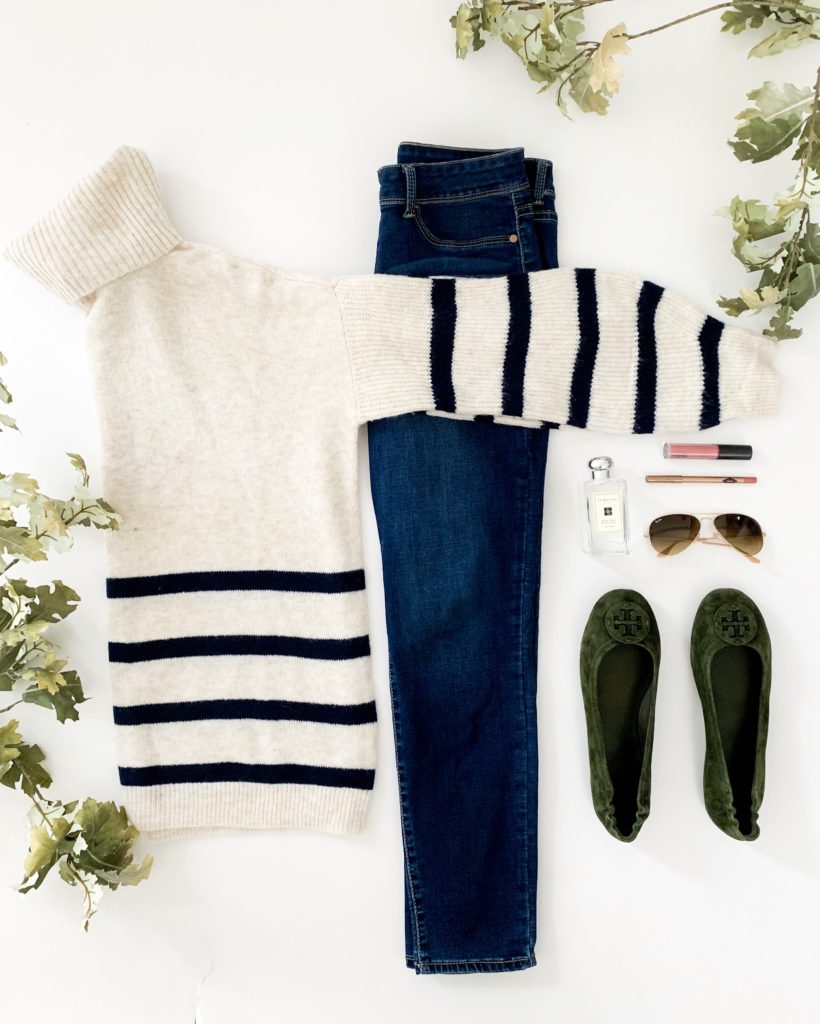 A white and blue striped sweater with jeans and green flat shoes.