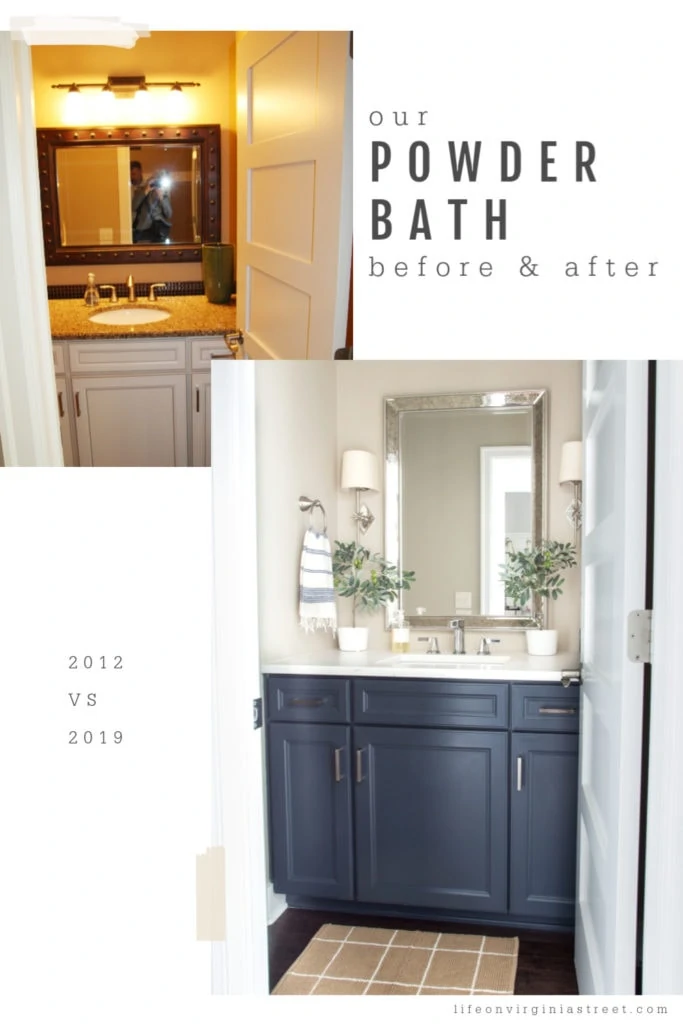 The small powder bathroom with navy blue cabinet and white counters.