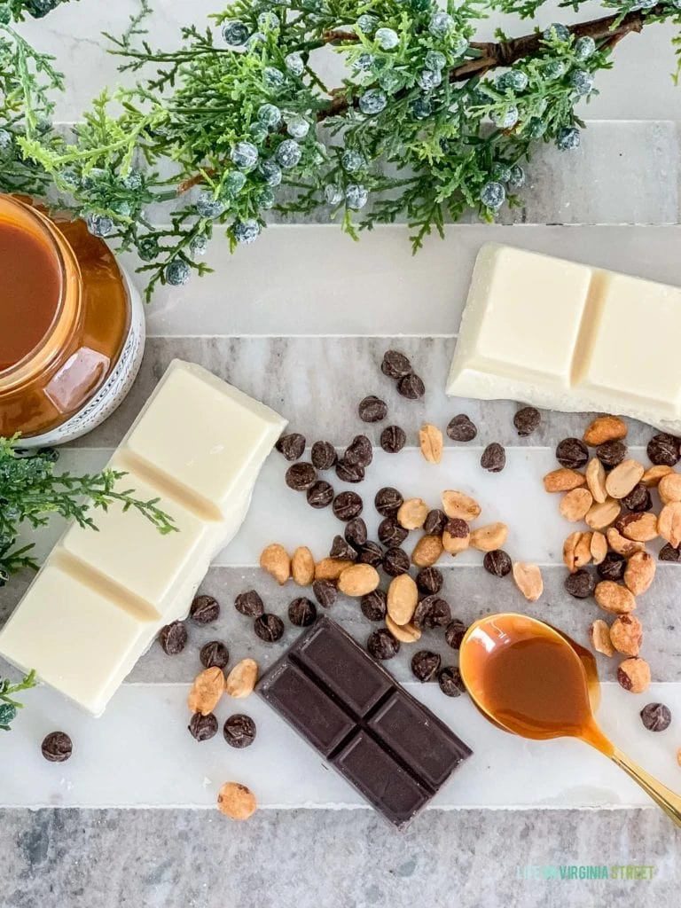 Chocolate white and dark, a spoon with caramel peanuts on the counter.