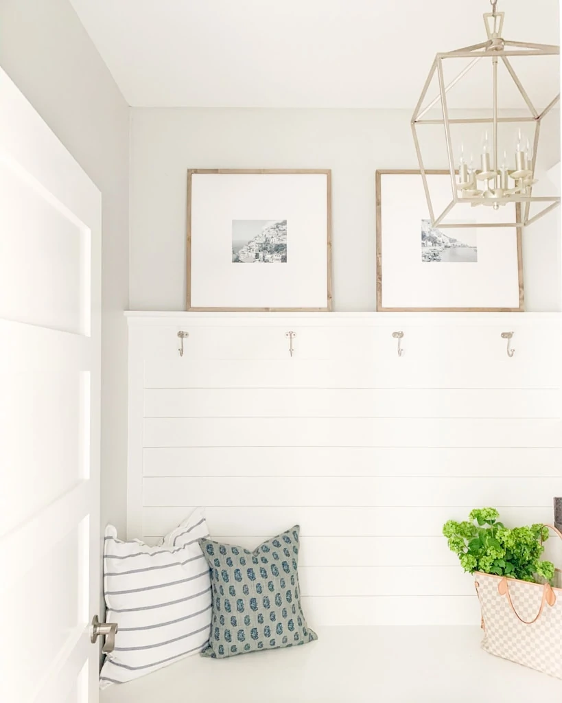 A small display of photos in a mudroom with blue and white decor.