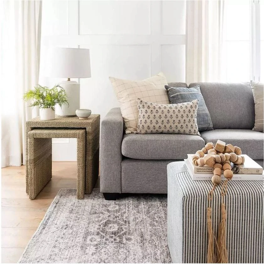 A beautiful living room designed with pieces from the Studio McGee collection at Target. I love woven nesting tables, white ceramic lamp, antique style rug, block print pillow, striped ottoman and wood beads.