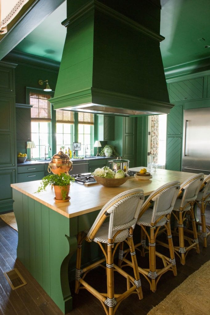 Sherwin Williams Evergreens Kitchen with hanging venthood, green walls, and Serena & Lily barstools.
