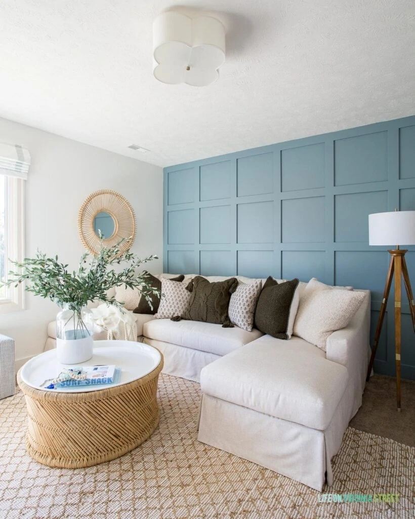A cozy den with a board and batten wall painted Benjamin Moore Van Courtland Blue with the side walls painted Benjamin Moore Simply White. An example of a gorgeous blue gray wall!