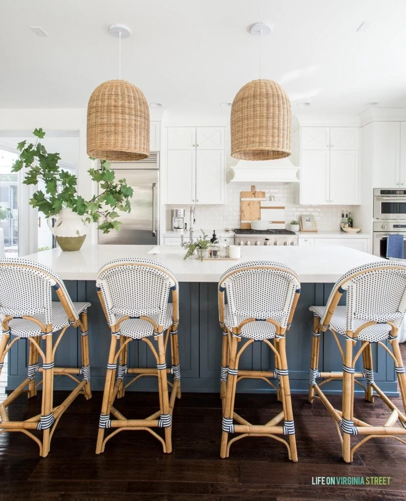 These bistro counter stools, basket pendant lights, wood charcuterie boards and runner rug in our coastal inspired kitchen are all part of my Serena Lily sale picks!