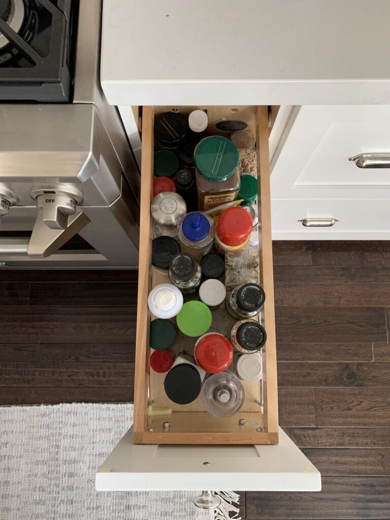A kitchen drawer that stores cooking pans and lids.