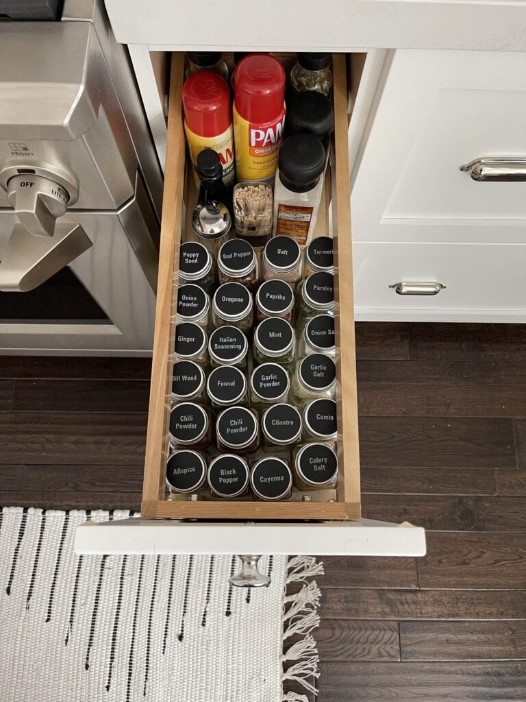 A kitchen drawer that stores pots, pans and mixing bowls.