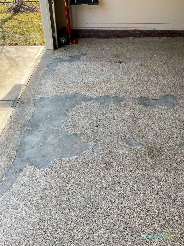 Peeling and flaking epoxy garage floor coating.