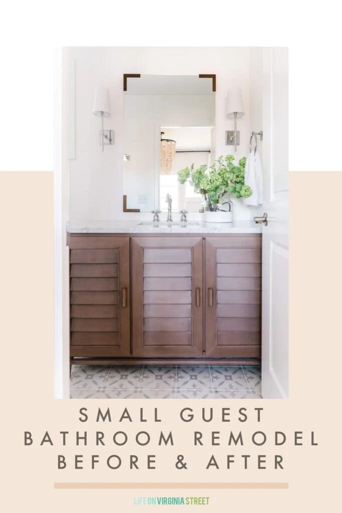 A before & after small guest bathroom remodel reveal featuring a louvered wood bathroom vanity, patterned tile floors, chrome sconce lights flanking a vertical mirror, and faux viburnum stems in a paint dipped vase.