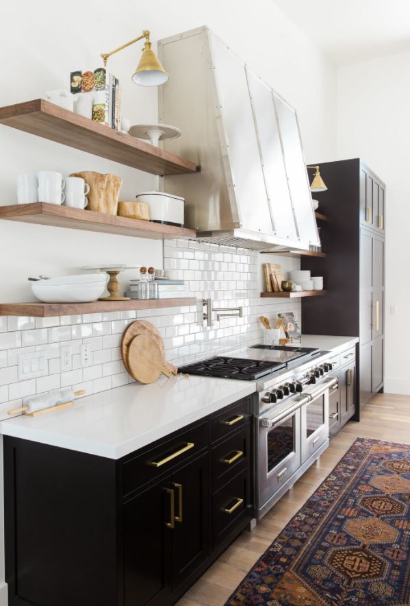 Sherwin Williams Tricorn Black painted lower cabinets in a white kitchen.