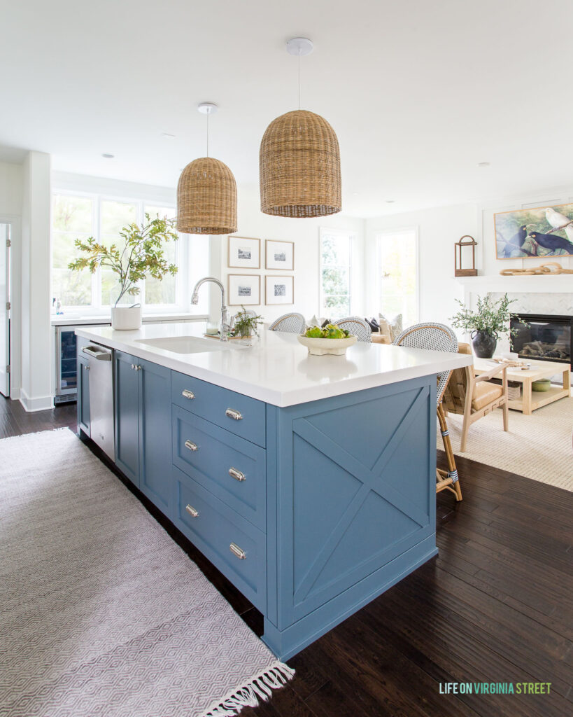 A kitchen decorated for fall with basket pendant lights and a kitchen island painted Benjamin Moore Providence Blue.