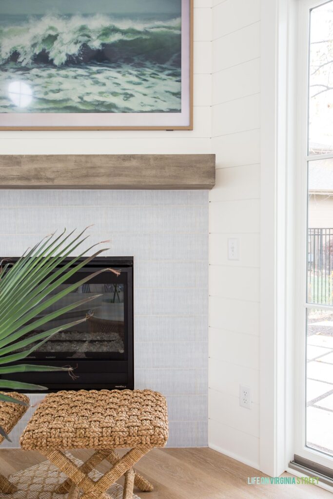 A look at our Annie Selke Watercolor Lines tile on our pool house fireplace wall. Also includes a floating mantel, woven stools, white shiplap walls, an a Frame TV.