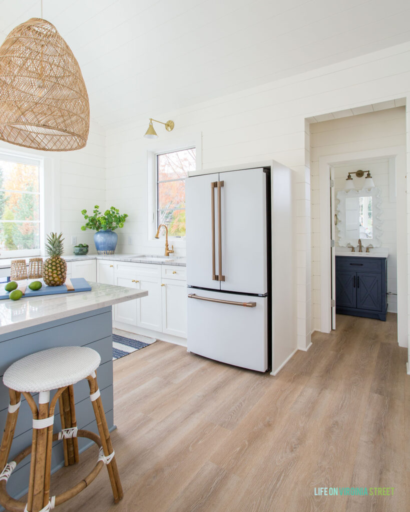 Our Cafe Appliances white matte refrigerator in our pool house kitchen. Also shows our LVP Lifeproof flooring!