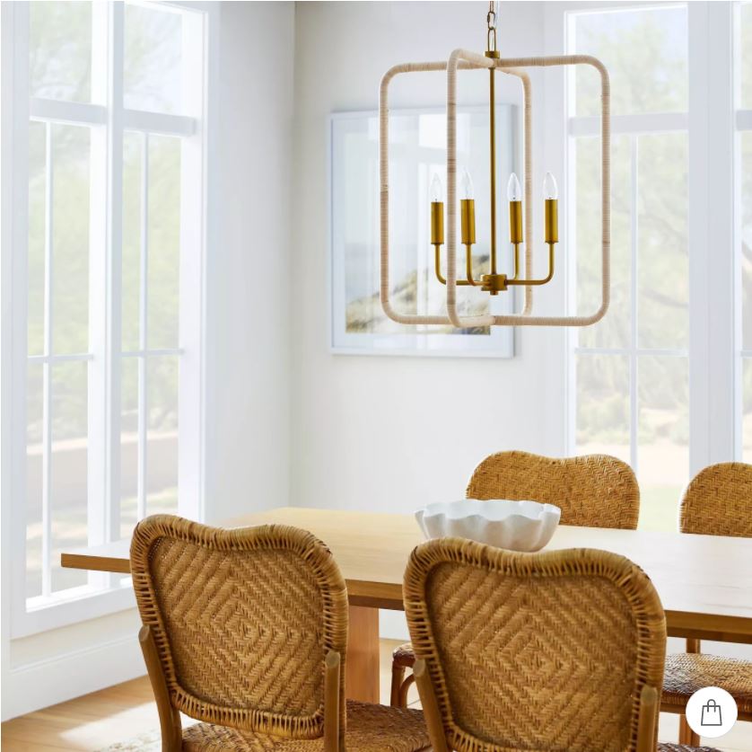 A dining room with woven rattan dining chairs and a seagrass lantern pendant light, all from the new Studio McGee collection at Target.