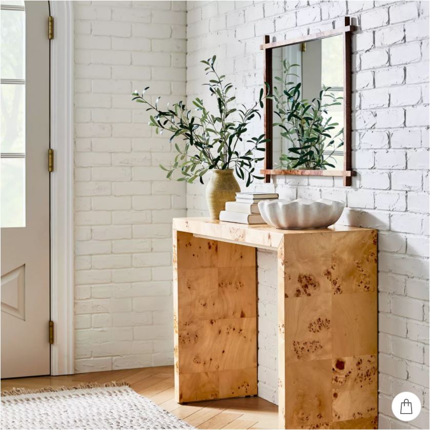 A burled wood console table decorated with faux olive stems, a scalloped bowl, and burl wood mirror. All part of the new Studio McGee collection at Target!