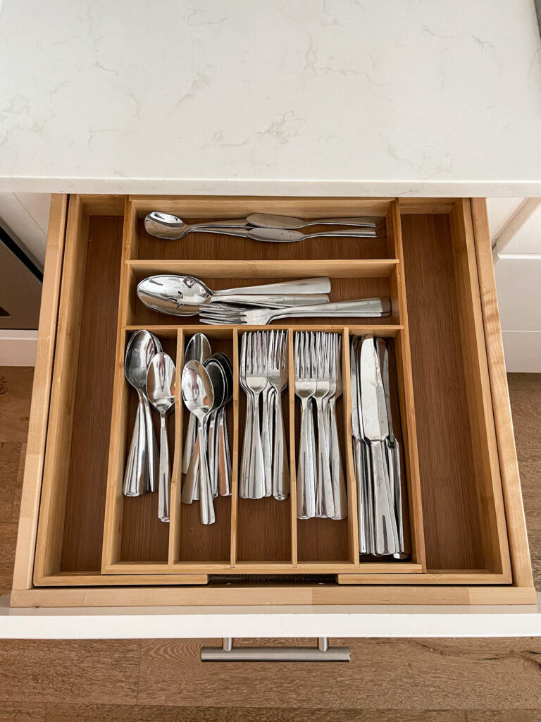 Affordable flatware from Amazon in a bamboo drawer organizer.