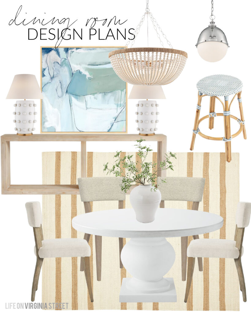Florida Coastal Cottage Design Plans for our dining room include blue abstract art, a wood bead chandelier, white cement dining table, upholstered dining chairs, white ceramic lamps, and some faux greenery!