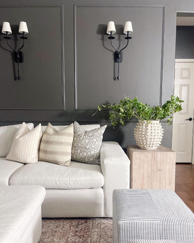 A cozy basement living room painted Sherwin Williams Urbane Bronze, one of the best brown paint colors with gray undertones.