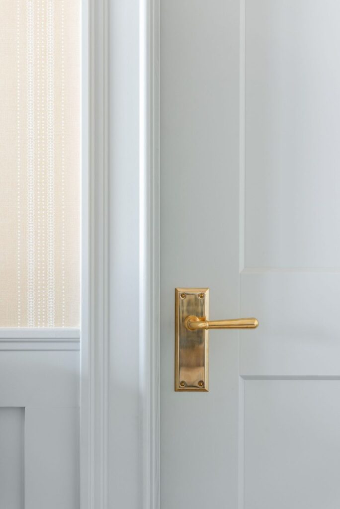Benjamin Moore Gray Owl interior painted door and trim with brass door hardware via Studio McGee.