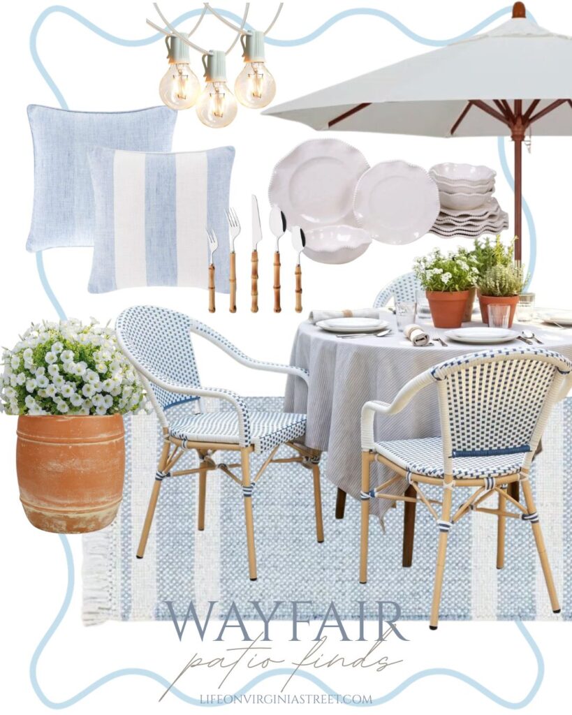 Nancy Meyers inspired patio dining space featuring coastal European furniture and decor like light blue striped pillows, bistro dining chairs, a market patio umbrella, terracotta planters, and more!